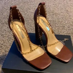 Brown with clear top high heels.  Gold chain strap.